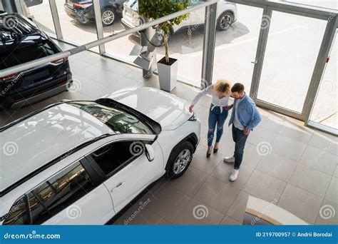 Persona eligiendo un coche en un concesionario
