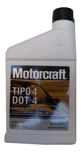 Primer plano de un frasco de líquido de frenos Motorcraft Super DOT 4 con un fondo de piezas de automóvil